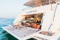 Luxury yacht Custom Line 112, 2007, with jet ski storage, docked on calm waters.
