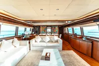 Luxurious yacht interior with white sofas, wooden accents, and ocean view, Custom Line 112, 2007.
