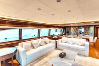 Luxurious interior of 2007 Custom Line 112 yacht with elegant sofas and vibrant artwork.