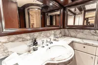 Luxurious marble bathroom in 2007 Custom Line 112 yacht, featuring elegant wood accents.