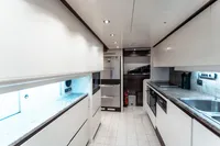 Luxurious yacht kitchen interior with modern appliances, sleek countertops, and ample storage, Custom Line 112, 2007.