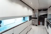 Luxurious yacht kitchen interior with modern appliances, sleek cabinetry, and ambient lighting, Custom Line 112, 2007.