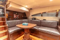 Luxurious yacht interior with leather seating, wooden table, and modern design, Custom Line 112, 2007.
