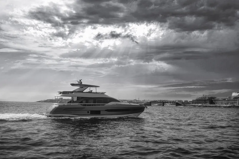  Yacht Photos Pics Azimut Fly 78 yacht cruising on the water under dramatic cloudy skies, 2022 model.