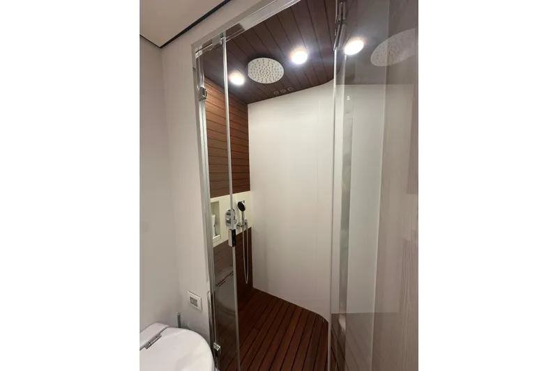  Yacht Photos Pics Luxurious shower area in 2022 Azimut Fly 78 yacht with modern fixtures and wooden accents.