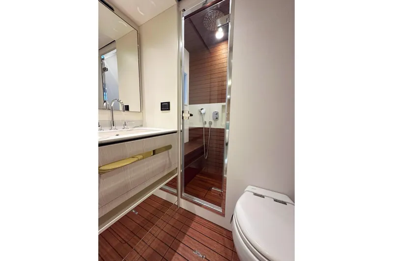  Yacht Photos Pics Luxurious bathroom in 2022 Azimut Fly 78 yacht with modern fixtures and wooden flooring.