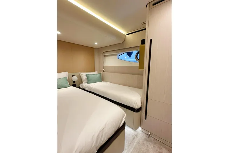  Yacht Photos Pics Luxurious twin bedroom in 2022 Azimut Fly 78 yacht, featuring modern design and cozy ambiance.