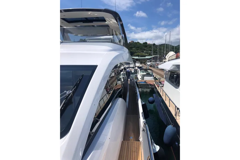  Yacht Photos Pics Azimut Fly 78 yacht, 2022 model, docked in a marina under a clear blue sky.