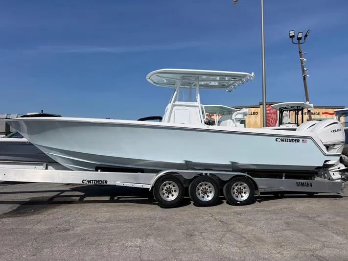  Yacht Photos Pics 2025 Contender 30 ST boat on trailer, side view, clear sky background.