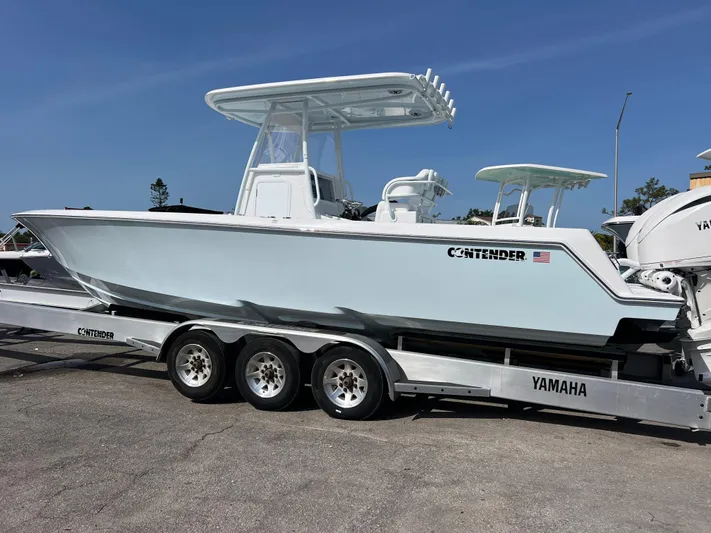  Yacht Photos Pics 2025 Contender 30 ST boat on a Yamaha trailer, parked outdoors.