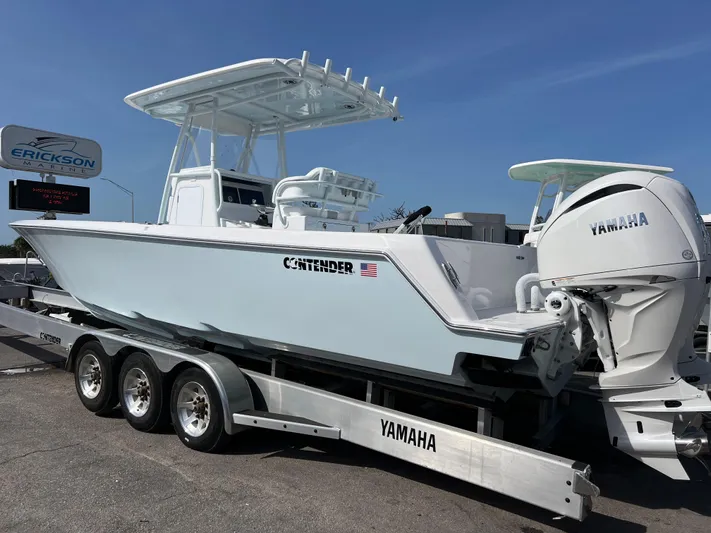  Yacht Photos Pics 2025 Contender 30 ST boat on a Yamaha trailer, displayed outdoors.