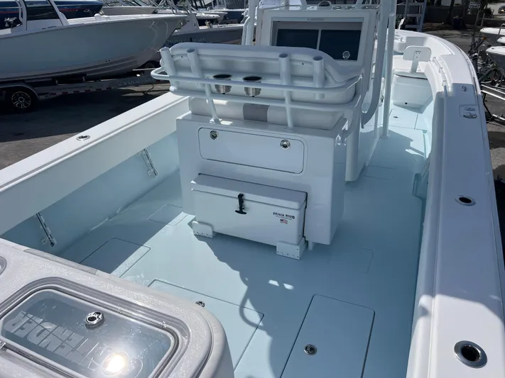  Yacht Photos Pics 2025 Contender 30 ST boat interior with seating and storage, docked in a marina.