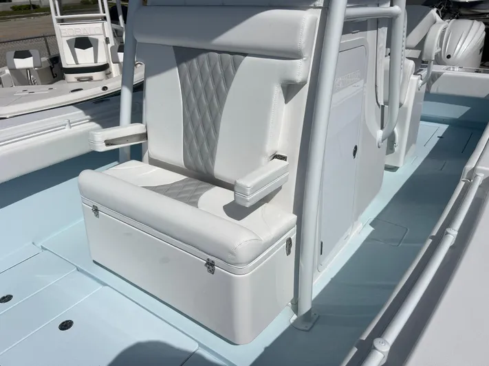  Yacht Photos Pics 2025 Contender 30 ST boat interior with white cushioned seating and storage.