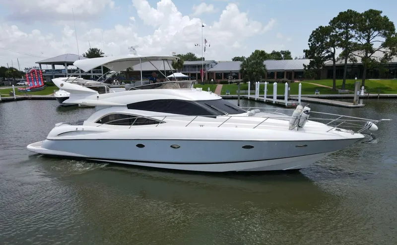 Prelude Yacht Photos Pics 2004 Sunseeker Manhattan 56 yacht cruising on a calm waterway.