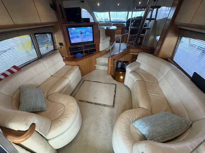 Prelude Yacht Photos Pics Luxurious interior of 2004 Sunseeker Manhattan 56 yacht with plush seating and entertainment system.