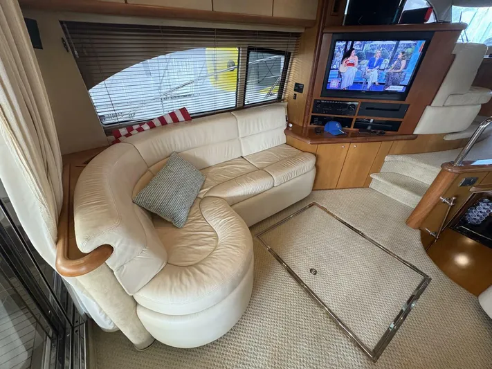 Prelude Yacht Photos Pics Luxurious interior of 2004 Sunseeker Manhattan 56 yacht with plush seating and entertainment system.