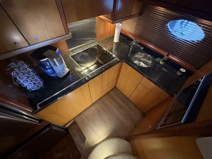 Prelude Yacht Photos Pics Luxurious 2004 Sunseeker Manhattan 56 yacht kitchen with modern appliances and sleek design.