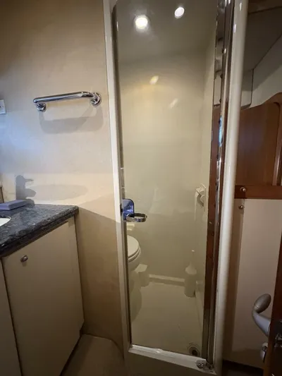 Prelude Yacht Photos Pics Bathroom interior of 2004 Sunseeker Manhattan 56 yacht with shower and sink.
