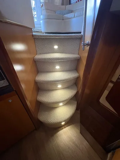 Prelude Yacht Photos Pics Carpeted stairs with lights on a 2004 Sunseeker Manhattan 56 yacht interior.