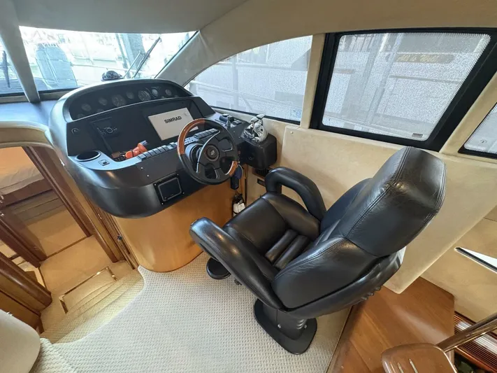 Prelude Yacht Photos Pics Luxurious helm of 2004 Sunseeker Manhattan 56 yacht with leather captain's chair.