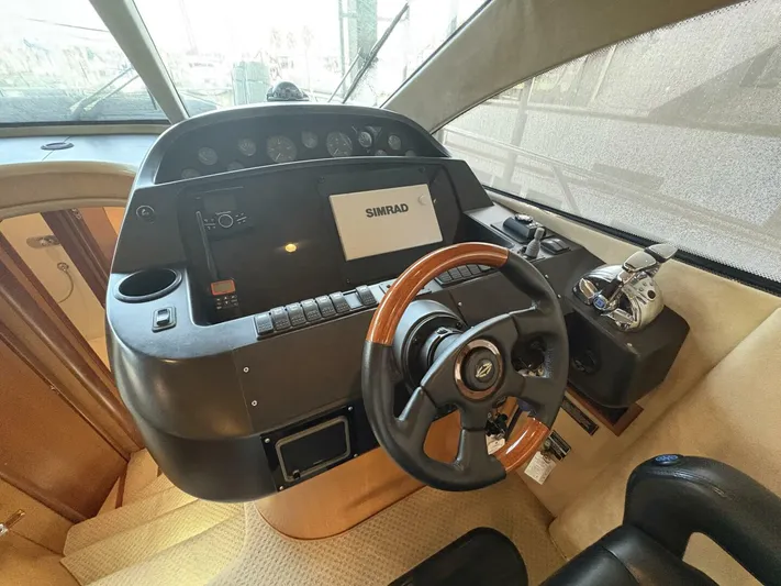 Prelude Yacht Photos Pics 2004 Sunseeker Manhattan 56 yacht helm with steering wheel and navigation controls.