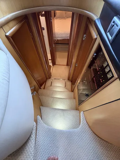 Prelude Yacht Photos Pics Staircase inside 2004 Sunseeker Manhattan 56 yacht, leading to cabin with wooden doors.