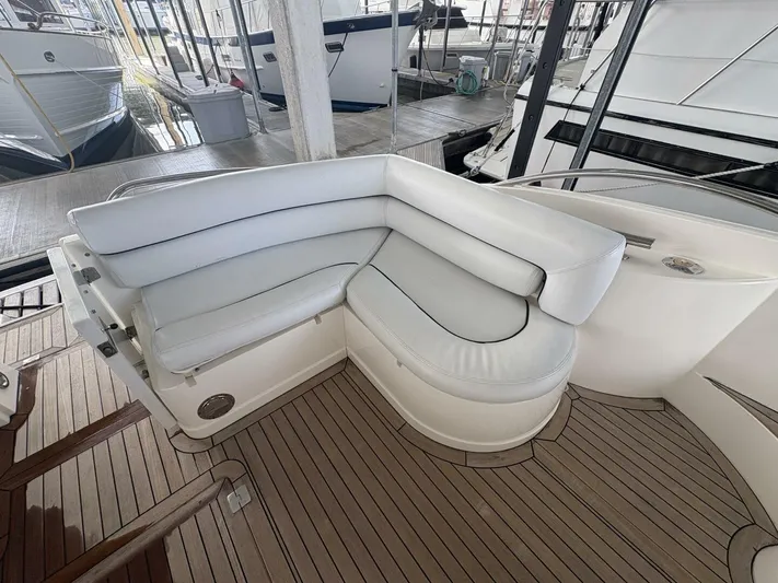 Prelude Yacht Photos Pics Luxury seating on 2004 Sunseeker Manhattan 56 yacht with elegant wooden deck.