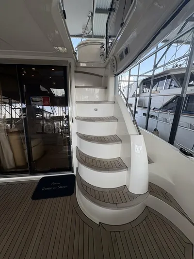 Prelude Yacht Photos Pics 2004 Sunseeker Manhattan 56 yacht interior with elegant staircase and sliding glass doors.