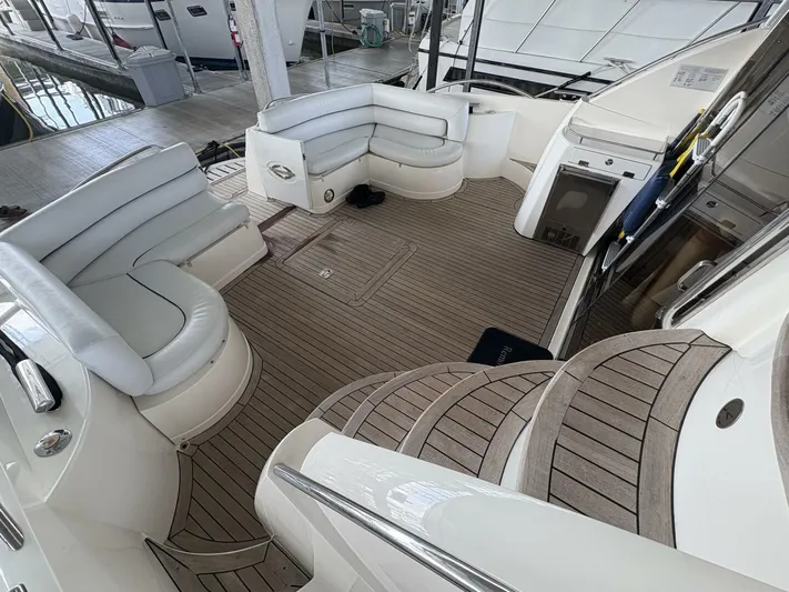 Prelude Yacht Photos Pics Luxurious 2004 Sunseeker Manhattan 56 yacht interior with elegant seating and wooden flooring.