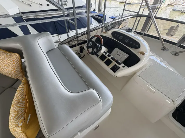 Prelude Yacht Photos Pics 2004 Sunseeker Manhattan 56 yacht helm with leather seating and modern controls.