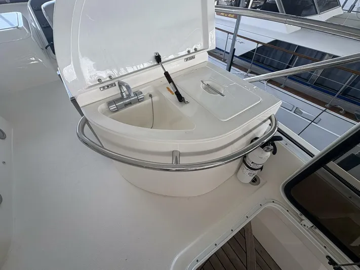 Prelude Yacht Photos Pics 2004 Sunseeker Manhattan 56 yacht sink area with faucet and safety equipment.