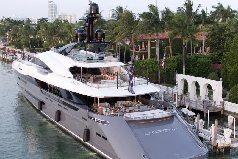 Utopia IV Yacht Photos Pics Luxurious 2018 Rossinavi Custom yacht docked near palm trees and elegant architecture.