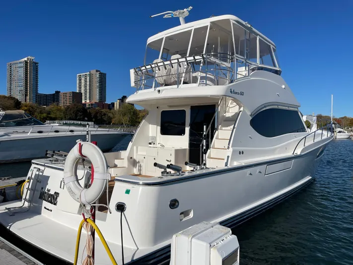 Resiliensea Yacht Photos Pics 2014 Nordhavn 60 Toro Convertible yacht docked at marina with city skyline.