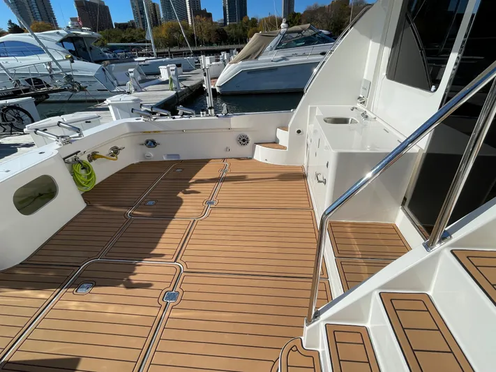 Resiliensea Yacht Photos Pics Nordhavn 60 Toro Convertible 2014 yacht deck with teak flooring at marina.