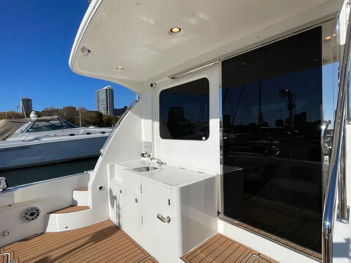 Resiliensea Yacht Photos Pics 2014 Nordhavn 60 Toro Convertible yacht deck with sink and city skyline view.