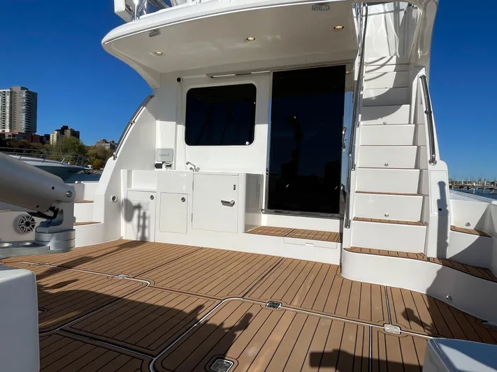 Resiliensea Yacht Photos Pics 2014 Nordhavn 60 Toro Convertible yacht deck with stairs and cabinetry, under clear blue sky.
