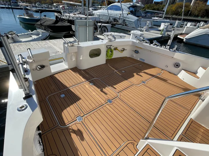 Resiliensea Yacht Photos Pics Nordhavn 60 Toro Convertible 2014 yacht deck with teak flooring at marina.