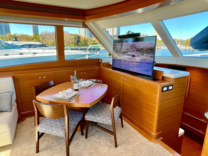 Resiliensea Yacht Photos Pics Luxurious 2014 Nordhavn 60 Toro Convertible yacht interior with dining area and TV.