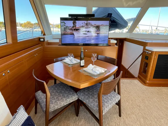 Resiliensea Yacht Photos Pics Luxurious dining area in 2014 Nordhavn 60 Toro Convertible yacht with elegant table setting.