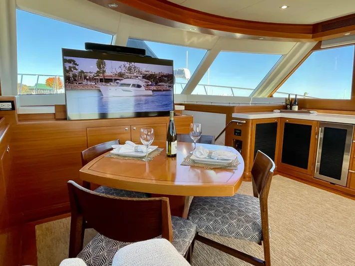 Resiliensea Yacht Photos Pics Luxurious interior of 2014 Nordhavn 60 Toro Convertible yacht with dining area and TV.