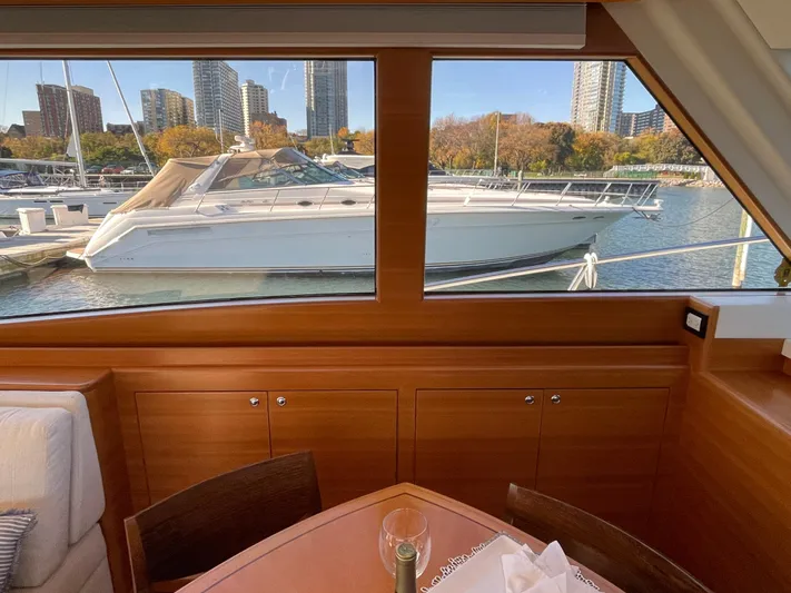 Resiliensea Yacht Photos Pics Interior view of 2014 Nordhavn 60 Toro Convertible yacht with marina backdrop.