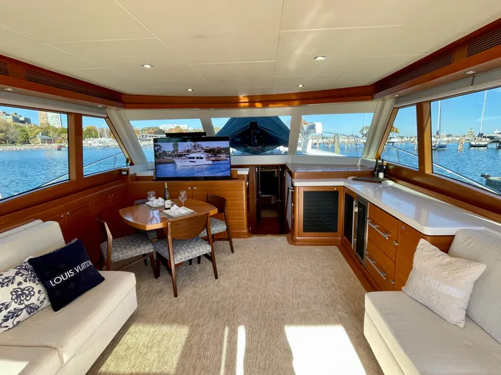 Resiliensea Yacht Photos Pics Luxurious interior of 2014 Nordhavn 60 Toro Convertible yacht with panoramic windows and elegant furnishings.