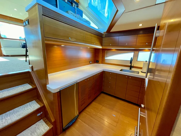 Resiliensea Yacht Photos Pics Luxurious kitchen interior of 2014 Nordhavn 60 Toro Convertible yacht with wood cabinetry.