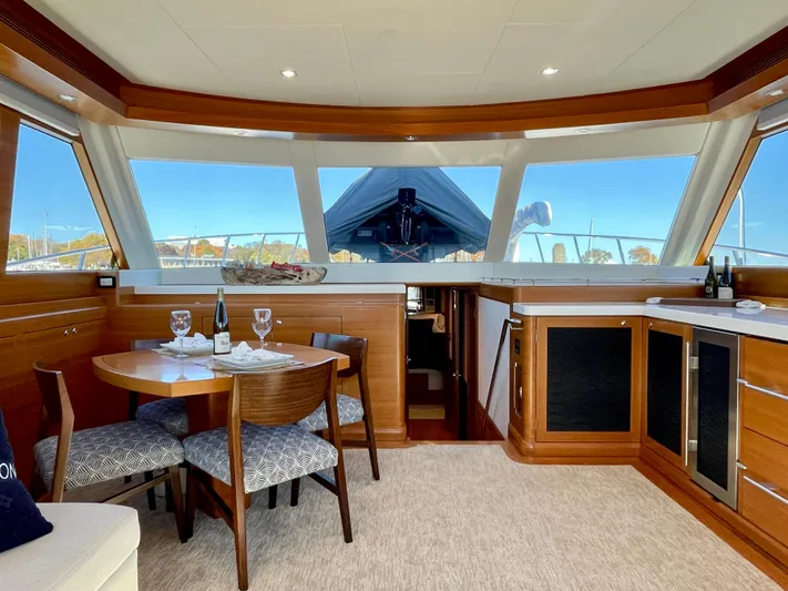 Resiliensea Yacht Photos Pics Luxurious interior of 2014 Nordhavn 60 Toro Convertible yacht with dining area and panoramic windows.