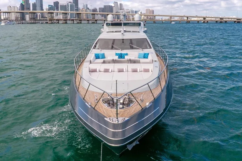 Nana I Yacht Photos Pics 2020 Mangusta 110 Open yacht on water with city skyline in background.