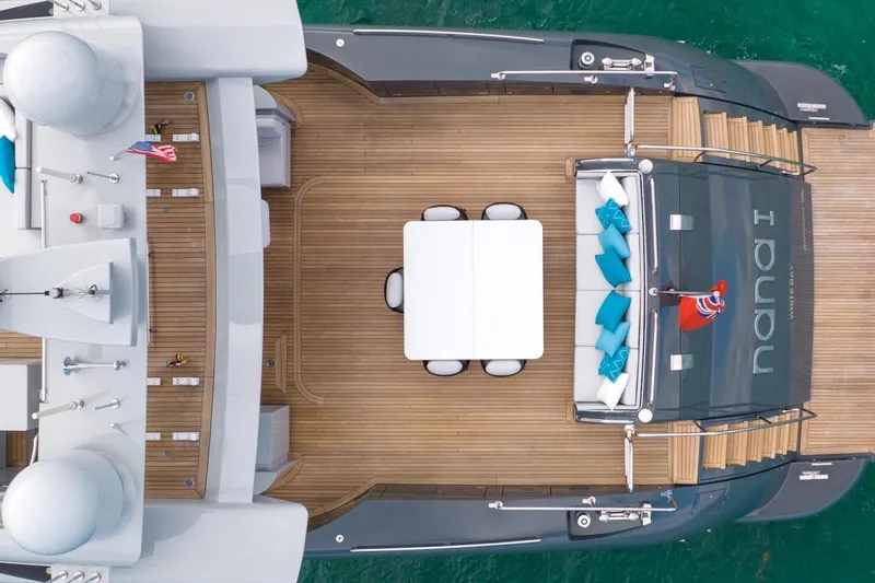 Nana I Yacht Photos Pics Aerial view of 2020 Mangusta 110 Open yacht deck with seating and table.