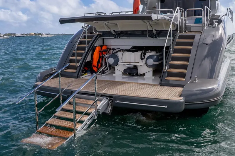 Nana I Yacht Photos Pics Sleek 2020 Mangusta 110 Open yacht with swim platform and steps in ocean.