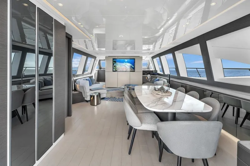 Nana I Yacht Photos Pics Luxurious interior of 2020 Mangusta 110 Open yacht with modern dining area and ocean views.