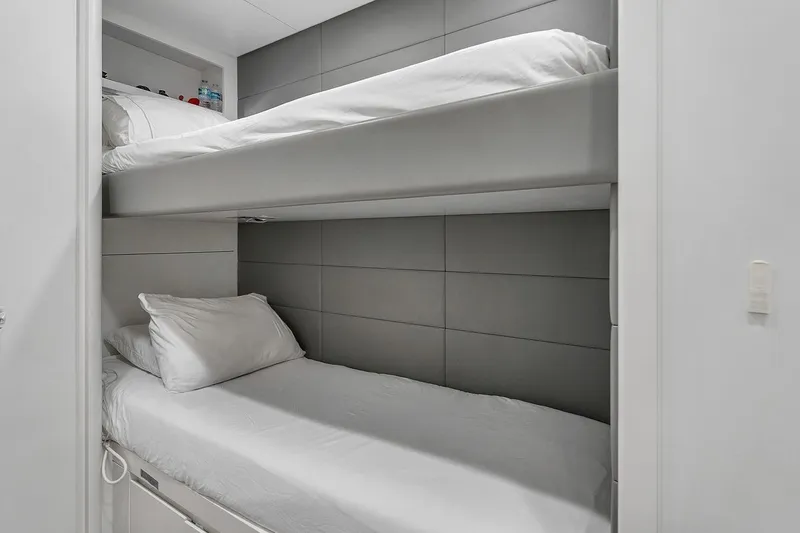 Nana I Yacht Photos Pics Bunk beds in a 2020 Mangusta 110 Open yacht cabin, featuring modern design and white linens.