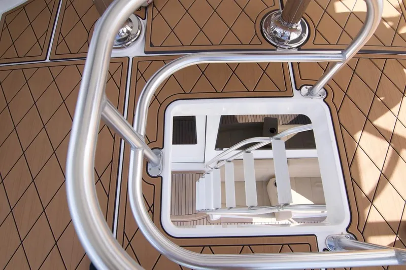 Serenity Now Yacht Photos Pics Stainless steel ladder on Viking 66 Convertible yacht, 2014 model, with teak-patterned deck.